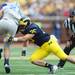 Michigan linebacker Joe Bolden reaches after Air Force full back Mike DeWitt during the first half at Michigan Stadium on Saturday. Melanie Maxwell I AnnArbor.com